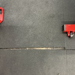 Hybrid Strength Athletics - One of many gaps in the rubber tiles in violation of the building code