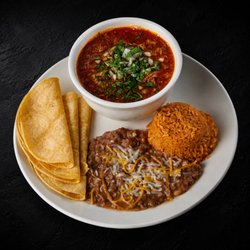 Hearty 32oz serving of tender birria in rich consommé, paired with rice, beans, and warm tortillas, topped with fresh onion and cilantro.