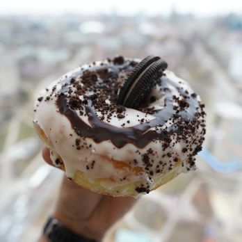 Dipped - a person holding a doughnut with ore cookies on it - Donuts Near Me - Toronto, Ontario