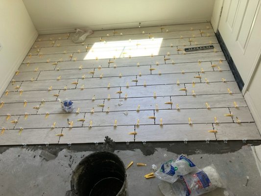 New Tiled Floor - We demolished the preexisting floor, leveled everything, and installed the new tile.
