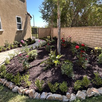Zion Landscape - A new garden bed with roses, hydrangeas, boxwood, and other bush plants. - Landscaping Near Me Zion Landscape - A new garden bed with roses, hydrangeas, boxwood, and other bush plants. - Landscaping Near Me