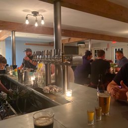 a group of people sitting at a bar