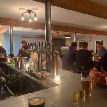 Drifters - a group of people sitting at a bar - Cocktail Bars Near Me - South Chatham, Massachusetts