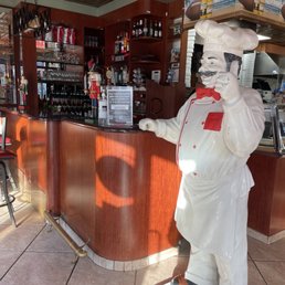a statue of a chef at the bar