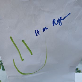 Pastrami Dans - a paper bag with a smiley face drawn on it - Tacos Near Me - Naples, Florida