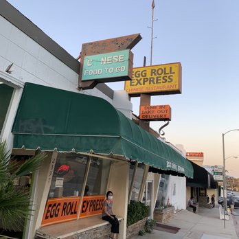 Egg Roll Express - a woman sitting outside of a restaurant - Chinese Near Me - Pasadena, California