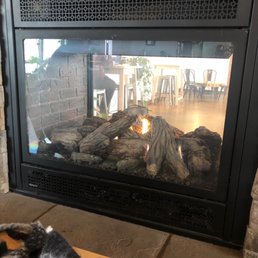 Fireplace that splits the two rooms.