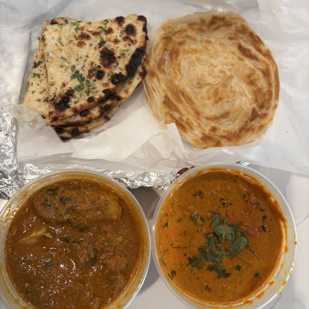 Biryani Pot - (Top left to right) Garlic naan, parotta, butter chicken and goat curry (bone-in) - Indian Near Me - Brentwood, California