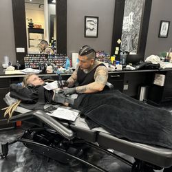 Dzul Ink Lounge - Listening to music with my arms up as Alex tattoos my abdomen