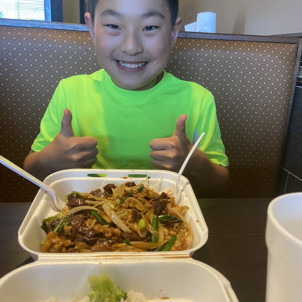 Happy boy with a mass of Mongolian beef and chicken. He left nothing behind. Happy boy with a mass of Mongolian beef and chicken. He left nothing behind.