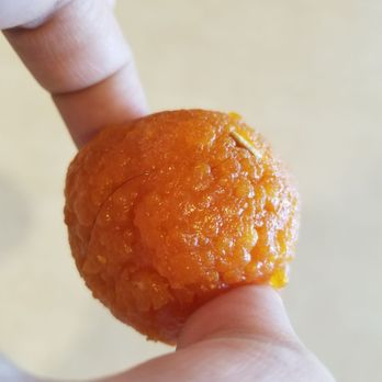Jot Indian Sweets & Restaurant - a hand holding an orange - Indian Near Me - Kent, Washington Jot Indian Sweets & Restaurant - a hand holding an orange - Indian Near Me - Kent, Washington