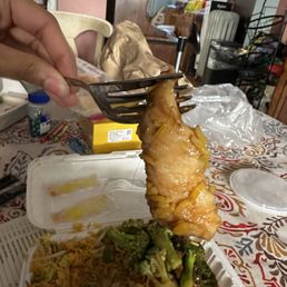 a person holding a fork over a plate of food a person holding a fork over a plate of food