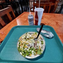 Burrito bowl with tortilla on the side.