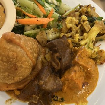 Annapoorna Indian Cuisine - My plate: goat curry, Chicken Tikka Masala, cauliflower, salad, and tikka masala sauce mixed with tamarind sauce for naan dipping. - Indian Near Me - Irvine, California