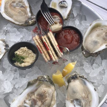Monty’s Lighthouse - 1/2 dozen oysters (cocktail sauce dipping in progress) - Sports Bars Near Me - Montgomery, Texas Monty’s Lighthouse - 1/2 dozen oysters (cocktail sauce dipping in progress) - Sports Bars Near Me - Montgomery, Texas
