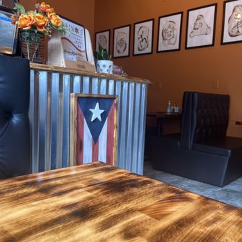 Taino's Kitchen - a table with a flag on it - Puerto Rican Near Me - Newark, New Jersey