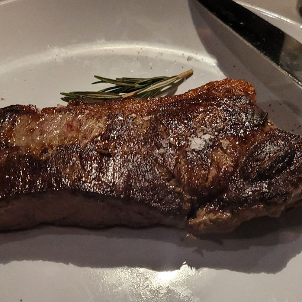 a steak on a plate with a knife and fork a steak on a plate with a knife and fork