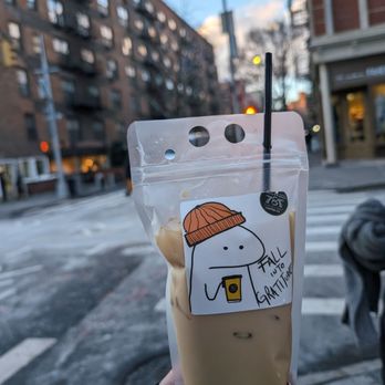 787 Coffee - a hand holding a bag of iced coffee - Coffee & Tea Near Me - New York, New York