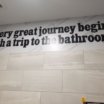 Chevron - a bathroom with a sign that says every great journey begins with a trip to the bathroom - Gas Stations Near Me - Las Vegas, Nevada
