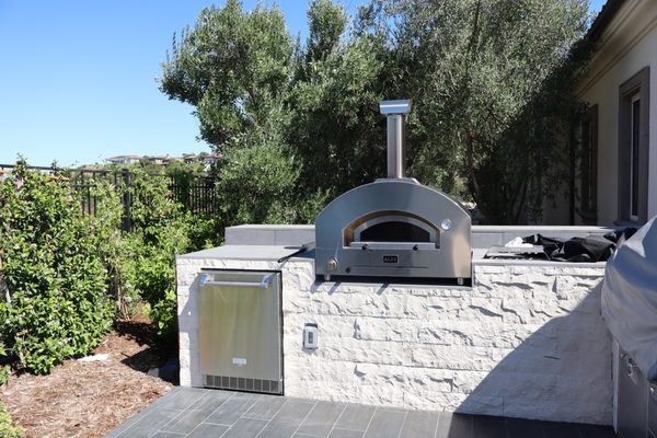 Pizza Oven and BBQ Specialists - Building a backyard pizza oven and BBQ can transform your outdoor space into a culinary haven and create a perfect setting for gatherings with family and friends. Start by selecting a suitable location that has enough space and ventilation, ensuring it complies with local building codes and safety regulations. Consider using fire-resistant materials such as brick, stone, or concrete to construct the structures, as they offer durability and heat retention. For the pizza oven, a dome-shaped design is popular because it distributes heat evenly, providing an authentic wood-fired pizza experience. Incorporate a chimney to direct smoke away from the cooking area. When designing the BBQ, decide between a charcoal or gas grill, depending on your cooking preference. Integrate storage and prep space for convenience. Personalize your setup with additional features like a countertop, sink, or even a small seating area to enhance functionality and comfort. Remember to plan for proper maintenance, and soon you'll be enjoying delicious homemade pizzas and barbecued delights right in your backyard. Pizza Oven and BBQ Specialists - Building a backyard pizza oven and BBQ can transform your outdoor space into a culinary haven and create a perfect setting for gatherings with family and friends. Start by selecting a suitable location that has enough space and ventilation, ensuring it complies with local building codes and safety regulations. Consider using fire-resistant materials such as brick, stone, or concrete to construct the structures, as they offer durability and heat retention. For the pizza oven, a dome-shaped design is popular because it distributes heat evenly, providing an authentic wood-fired pizza experience. Incorporate a chimney to direct smoke away from the cooking area. When designing the BBQ, decide between a charcoal or gas grill, depending on your cooking preference. Integrate storage and prep space for convenience. Personalize your setup with additional features like a countertop, sink, or even a small seating area to enhance functionality and comfort. Remember to plan for proper maintenance, and soon you'll be enjoying delicious homemade pizzas and barbecued delights right in your backyard.