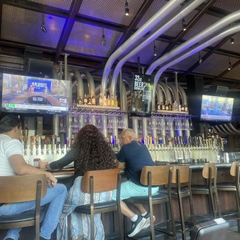 Yard House - The Bar in the middle. Very spacious and inviting for all occasions. - New American Near Me - Dallas, Texas