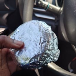 a hand holding a piece of tin foil