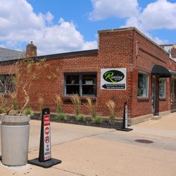 Running Niche - Exterior view of Running Niche on Tower Grove Ave, with clear signage and driveway entrance to customer parking