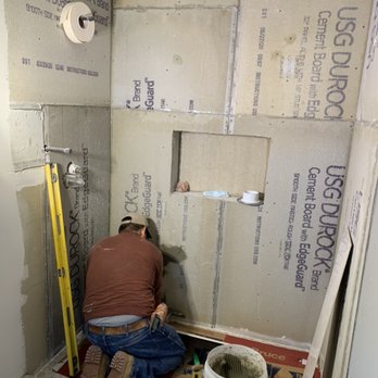 Quality Pro - a man working in a bathroom under construction - Painters Near Me
