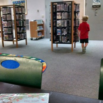 Miami Dade Public Library System - Main Library - Choosing DVDs in the children's area - Libraries Near Me - Miami, Florida