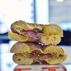 Bite the Bagel Deli Cafe - Italian Ham-Hot Thin Ham, Pesto Sauce, Roasted Red Peppers topped with melted Provolone Cheese on a fresh baked Garlic Bagel.