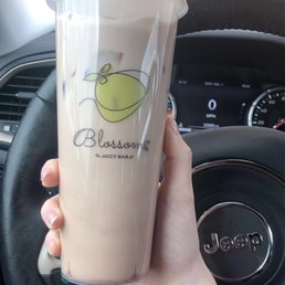 a hand holding a cup of iced coffee a hand holding a cup of iced coffee