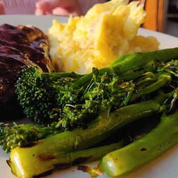 Mural Room - Bison ribeye with yukon mashed potato and broccolini with huckleberry demiglace - American Near Me - Moran, Wyoming