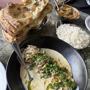 Calcutta Cricket Club - Murgh Makani (back) and chicken Malai (front) with basmati rice and naan - Indian Near Me - Calgary, Alberta Calcutta Cricket Club - Murgh Makani (back) and chicken Malai (front) with basmati rice and naan - Indian Near Me - Calgary, Alberta