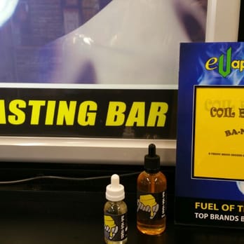 eVaporFuel - a bottle of evaporfuel next to a free tasting bar sign - Convenience Stores Near Me - Holiday, Florida