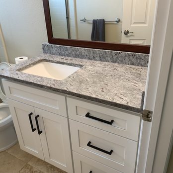 MH CABINETS - a bathroom with a marble counter top - General Contractors Near Me - Palm Bay, Florida MH CABINETS - a bathroom with a marble counter top - General Contractors Near Me - Palm Bay, Florida