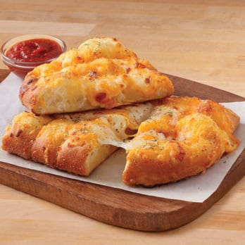 Domino's Pizza - a cheesy pizza cut into four pieces - Pizza Near Me - Caledon, Ontario