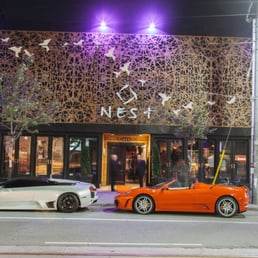 two sports cars parked in front of a building