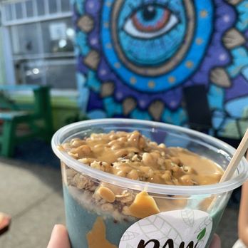 Raw Juice Cafe - a hand holding a cup of ice cream - Juice Bars & Smoothies Near Me - Flagler Beach, Florida