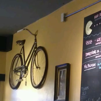 Spokeasy Public House - Bicycle emerging from the wall. - Pubs Near Me - Fresno, California Spokeasy Public House - Bicycle emerging from the wall. - Pubs Near Me - Fresno, California
