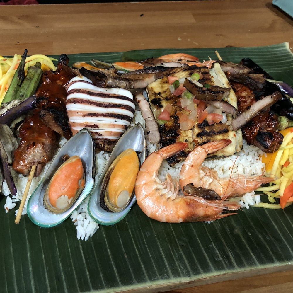 Tinuno - Kamayan - pork skewer, milkfish (yellow on the right of squid) and mango salad (corners) were the highlight! - Filipino Near Me - Toronto, Ontario Tinuno - Kamayan - pork skewer, milkfish (yellow on the right of squid) and mango salad (corners) were the highlight! - Filipino Near Me - Toronto, Ontario