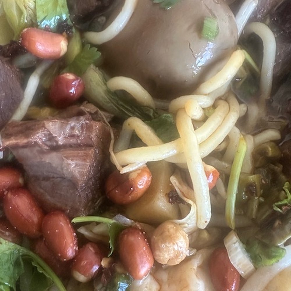 Delicious beef mifen noodle soup with a teriyaki egg Delicious beef mifen noodle soup with a teriyaki egg