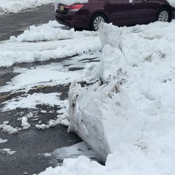 Kramer-Triad Management Group - Parking lot plowed by Cmark, snow piled in front of cars and in parking spaces instead of remove.