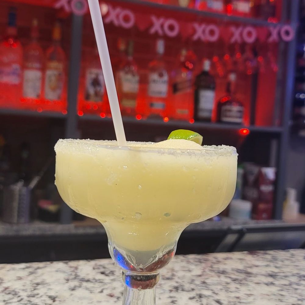 Back Home Restaurant and Bar - a margarita in a glass with a straw - Comfort Food Near Me - Greenacres, Florida Back Home Restaurant and Bar - a margarita in a glass with a straw - Comfort Food Near Me - Greenacres, Florida