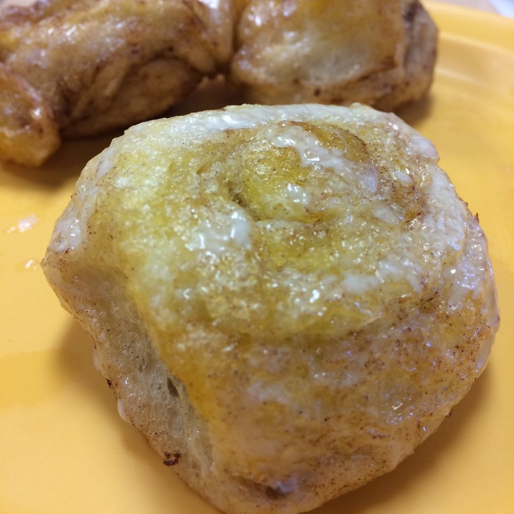 A decadent cinnamon roll drizzling with deliciousness A decadent cinnamon roll drizzling with deliciousness