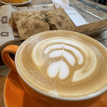 Macondo Coffee Roasters - Cappuccino and flat bread sandwich. - Coffee & Tea Near Me - Doral, Florida Macondo Coffee Roasters - Cappuccino and flat bread sandwich. - Coffee & Tea Near Me - Doral, Florida