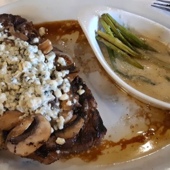 Lucky's Steakhouse - Rib eye topped with mushrooms, onions and gorgonzola cheese with a side of asparagus. So good! - Steakhouses Near Me - Okemos, Michigan