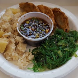 Vegetarian potstickers with coconut pineapple rice and seaweed salad.