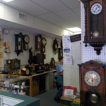 Swiss House - Bart, hard at work amongst the wall clocks - Watch Repair Near Me - Orlando, Florida
