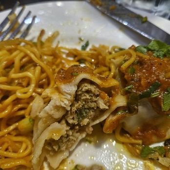Himalayan Aroma Restaurant - Sizzler Lamb Momo Steamed momo (ground lamb dumplings) served in a hot plate on a bed of sauteed noodles. - Himalayan/Nepalese Near Me - Corona, California Himalayan Aroma Restaurant - Sizzler Lamb Momo Steamed momo (ground lamb dumplings) served in a hot plate on a bed of sauteed noodles. - Himalayan/Nepalese Near Me - Corona, California