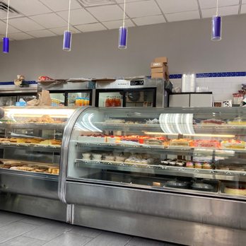 Pitusa Bakery - a woman standing in front of the counter - Bakeries Near Me - Bronx, New York